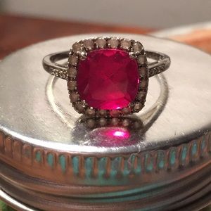 Ruby colored ring with halo detail